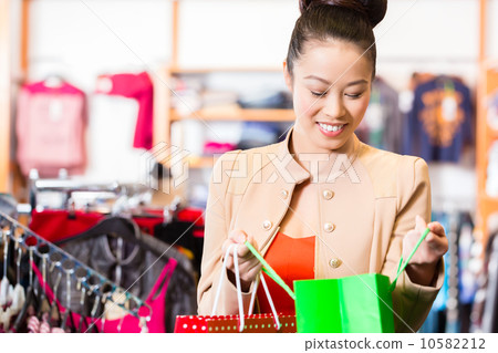 Asian Woman with shopping bags in shop Asian Woman with shopping bags in shop 10582212