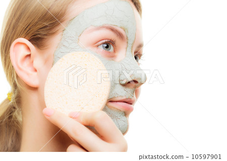 Skin care. Woman removing clay mud facial mask Skin care. Woman removing clay mud facial mask 10597901