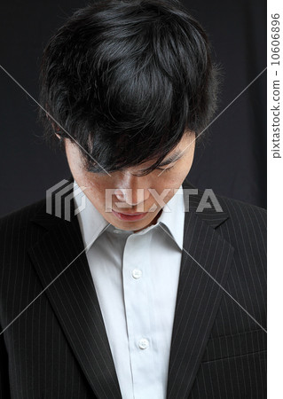 young asian man looking down 10606896