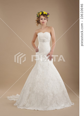Charming Woman in Bridal Dress with Wreath of Flowers 10610646
