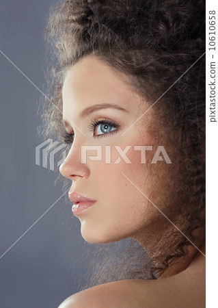 Profile of Young Brunette Fashion Model with Frizzy Hair 10610658
