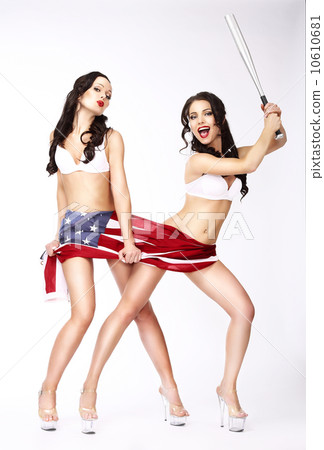 Laughing Women with American Flag and Baseball Bat Having Fun Laughing Women with American Flag and Baseball Bat Having Fun 10610681
