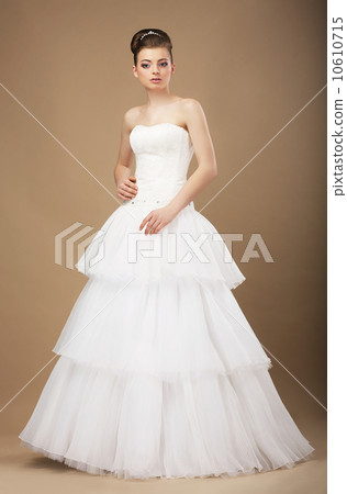 Caucasian Woman in White Long Dress Posing in Studio 10610715