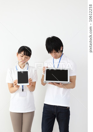 A staff member watching a computer with a troubled face A staff member watching a computer with a troubled face 10612258