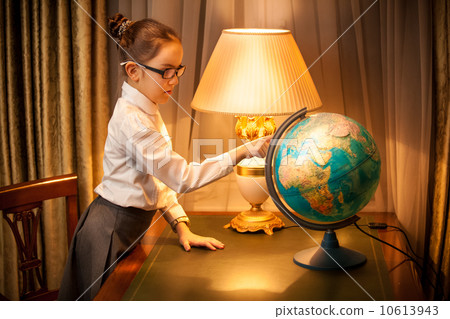 Young schoolgirl studying globe 10613943