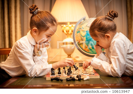 Girls in school uniform playing chess 10613947