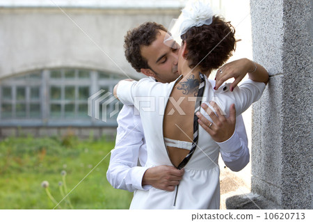 Woman with a tattoo kisses the man. Woman with a tattoo kisses the man. 10620713