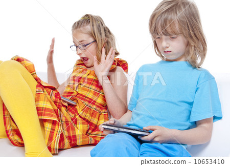 Two Children Having Fun with Digital Gadgets 10653410
