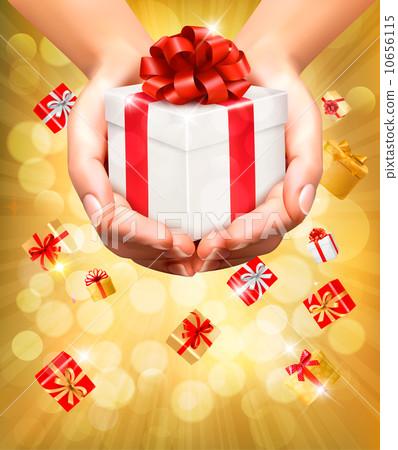 Holiday background with hands holding gift boxes. Concept of giv 10656115