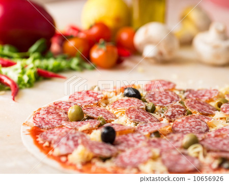 raw salami italian pizza with capers raw salami italian pizza with capers 10656926