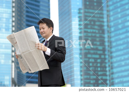 Successful entrepreneur stock agent business man reading newspaper in front of glass office building Successful entrepreneur stock agent business man reading newspaper in front of glass office building 10657021