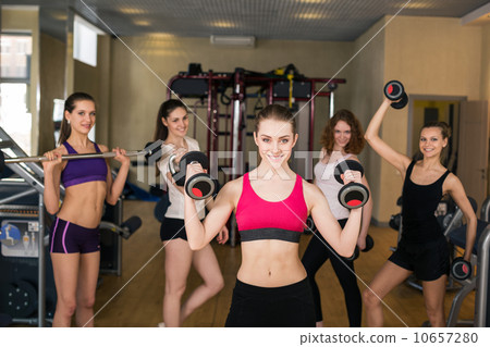 Smiling trainer in front of group 10657280