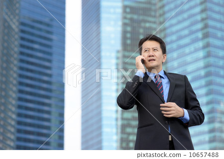 Successful entrepreneur business man using mobile phone in front of glass office building Successful entrepreneur business man using mobile phone in front of glass office building 10657488