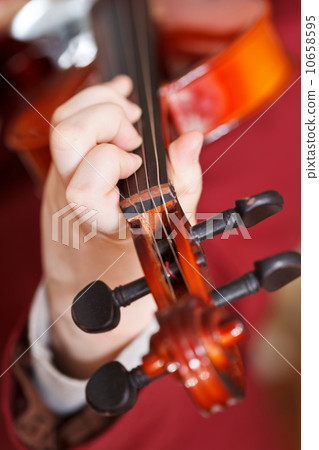 girl plays on fiddle - chord on fingerboard girl plays on fiddle - chord on fingerboard 10658595