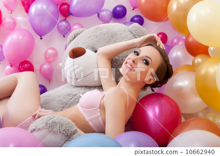 Cheerful beautiful girl posing with big teddy bear Cheerful beautiful girl posing with big teddy bear 10662940