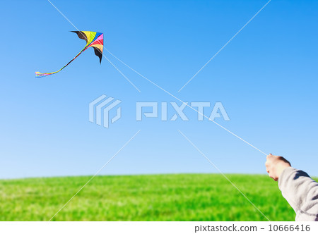 hand holding a kite against the sky 10666416