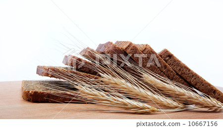 Fresh bread isolated on a wooden table. Fresh bread isolated on a wooden table. 10667156