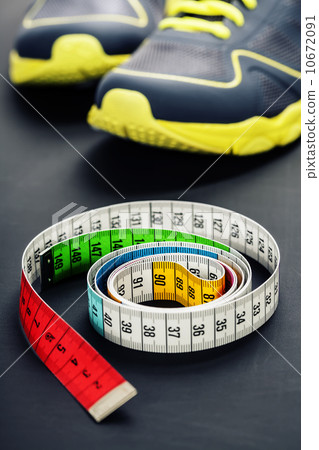 Sport shoes and measuring tape Sport shoes and measuring tape 10672091