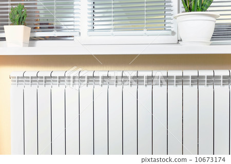 Heating white radiator radiator with flower and window. Heating white radiator radiator with flower and window. 10673174