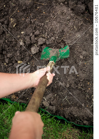 photo of gardener digging soil with shovel photo of gardener digging soil with shovel 10676481