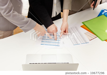 Three women who point at documents Three women who point at documents 10677296