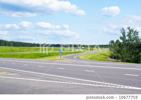 Road, gren grass and blue sky 10677758