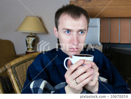 A man drinking from white cup A man drinking from white cup 10678859