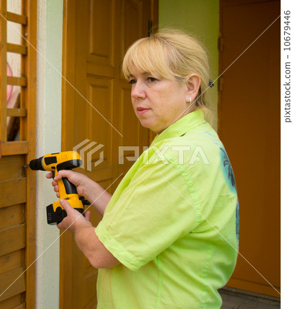 A woman with a screwdriver 10679446