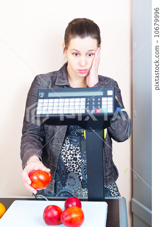 girl weighing peach in the market girl weighing peach in the market 10679996