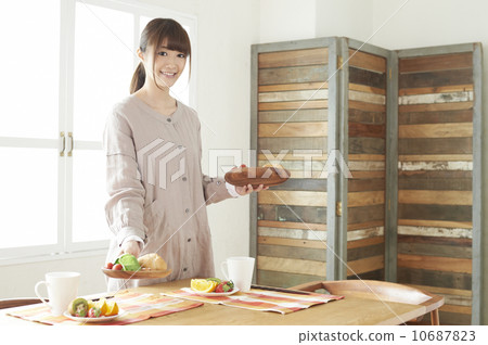 A woman serving breakfast A woman serving breakfast 10687823