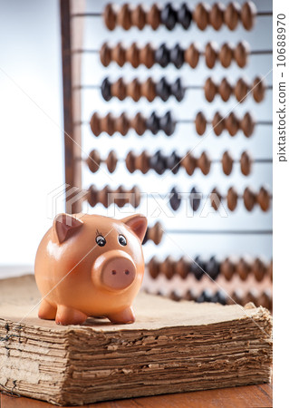 Piggy bank on old book 10688970