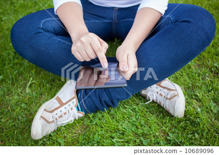 Woman using digital tablet PC Woman using digital tablet PC 10689096