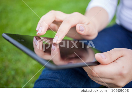 Woman using digital tablet PC Woman using digital tablet PC 10689098