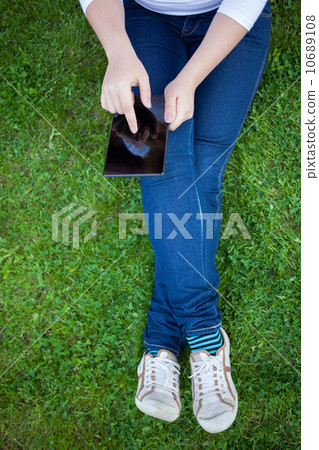 Woman using digital tablet PC Woman using digital tablet PC 10689108