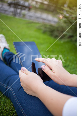 Woman using digital tablet PC Woman using digital tablet PC 10689109
