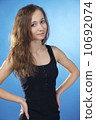 Isolated on blue brunette woman with arms akimbo 10692074