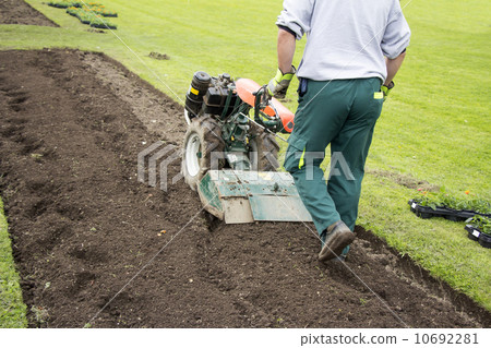Man rototilling the ground 10692281