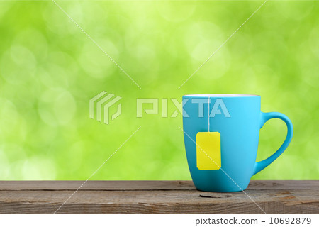 Cup of tea on green nature background 10692879