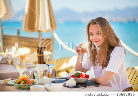 Beautiful young woman in a beach restaurant 10692989