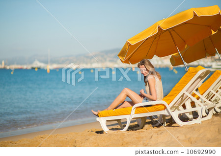 Beautiful girl relaxing on a beach chair 10692990