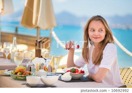 Beautiful young woman in a beach restaurant 10692992
