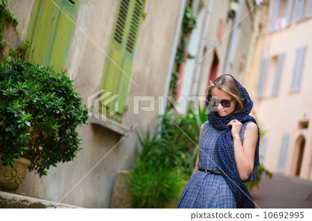 Elegant young woman in the Old town of Cannes 10692995
