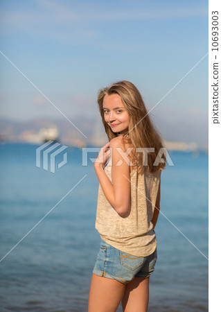 Beautiful young woman at the beach 10693003