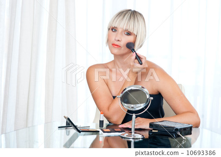 attractive woman putting make up attractive woman putting make up 10693386