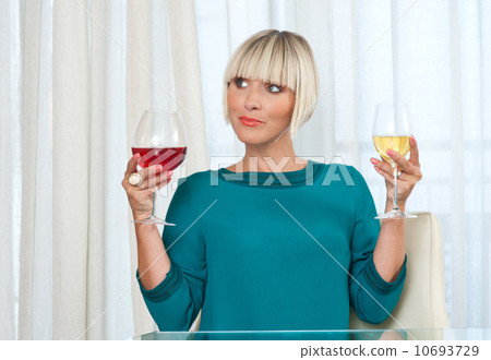 woman choosing betwean red and white wine woman choosing betwean red and white wine 10693729