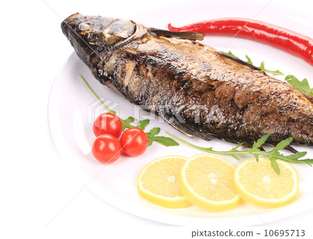 Fried carp with lemon and rukkola. 10695713