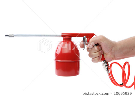 Hand holds spray gun with plastic spring. 10695929