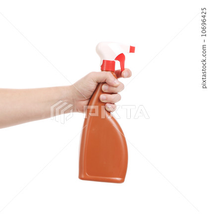 Hand holding brown plastic spray bottle. Hand holding brown plastic spray bottle. 10696425
