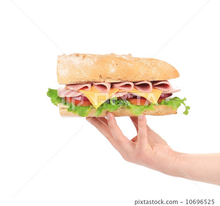 Hand holding baguette sandwich. Hand holding baguette sandwich. 10696525
