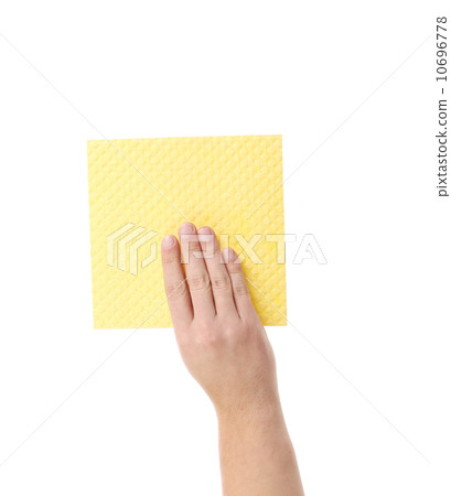 Hand holds yellow cleaning sponge. 10696778